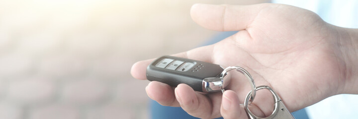 Fototapeta premium Car remote key in hand. Selective focus