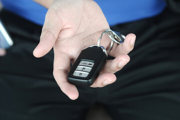 Car remote key in hand. Selective focus