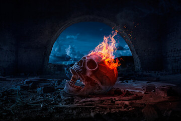 Skull burned in fire in dark Halloween night. Concept of Halloween