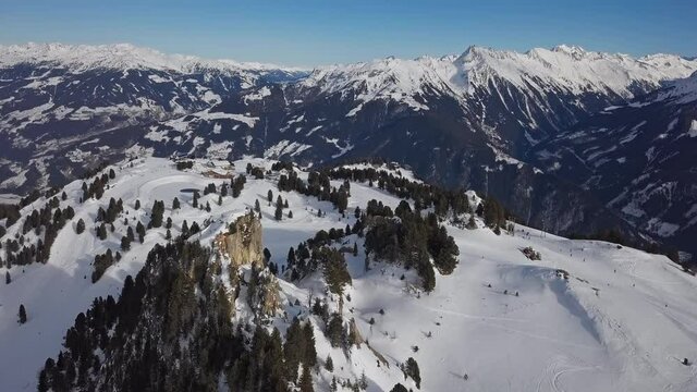 Aerial view of skiers on ski slopes in Penken area, Mayrhofen ski resort, Tyrol, Austria.
