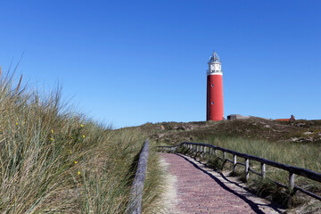 Fototapeta na wymiar The Red Lighthouse of Texel Nationalpark De Cocksdorp Netherlands.