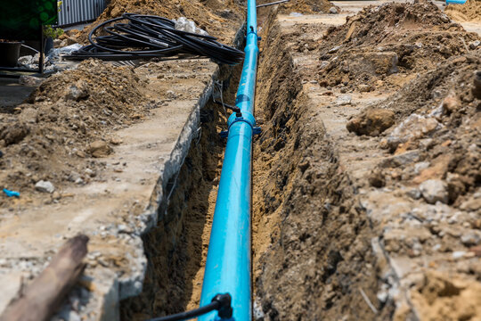 Construction Site With New Water Pipes In The Ground. Sewer Pipes To Repair Or Restore In Street City