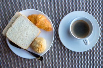 Breakfast with bread, croissants and black coffee composition. breakfast with black coffee and bread.