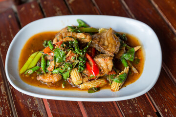 Spicy stir-fried fish with pepper, chili . Stir fried fish with Thai herbs, spicy local food, the unique spice of Thai food. image for objects copy space and menu list. fire Catfish Spicy