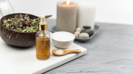 Bottle natural organic oil essence serum with healing herbs and sea salt. Aromatherapy and beauty. Concept set of harmony, balance and meditation, spa, massage, relax, beauty spa treatment.