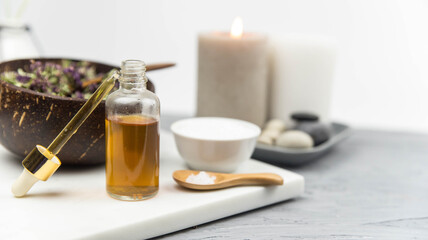 Bottle natural organic oil essence serum with healing herbs and sea salt. Aromatherapy and beauty. Concept set of harmony, balance and meditation, spa, massage, relax, beauty spa treatment.