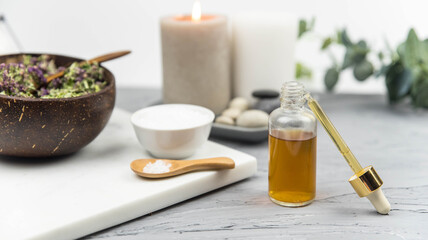 Bottle natural organic oil essence serum with healing herbs and sea salt. Aromatherapy and beauty. Concept set of harmony, balance and meditation, spa, massage, relax, beauty spa treatment.