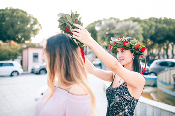 Corone di laurea italiana con foglie di alloro e università
