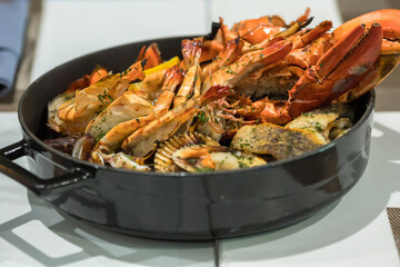 Seafood platter. Grilled lobster and sea food on pan.