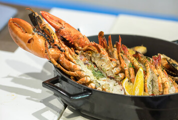 Seafood platter. Grilled lobster and sea food on pan.