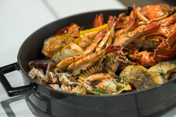 Seafood platter. Grilled lobster and sea food on pan.