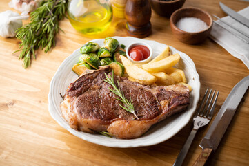 new york strip steak with french fries and brussels sprout
