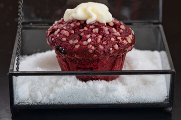 Homemade cherry muffins sprinkled with wipped cream standing in sugar on in a glass basket