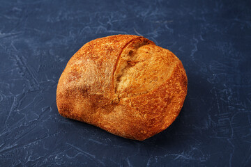 Bakery - gold rustic crusty loaves of bread and buns on blue chalkboard background.