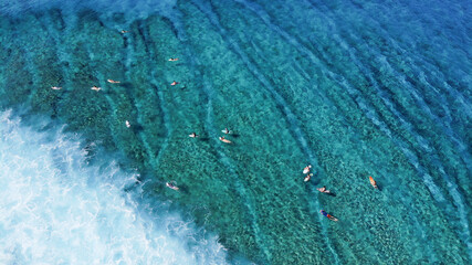 A beautiful drone photography of Maldives. The clear ocean with different tons of blue, the coral reef and the green palm trees makes that place special destination for tourism.