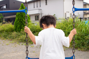 Japanese kindergarten children playing with playground equipment in a park in Gifu prefecture