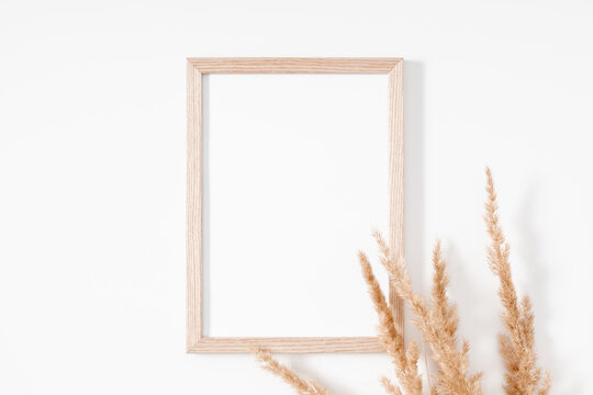 Autumn creative composition. Photo frame, Beige reeds branches bouquet on white background. Fall concept. Autumn background. Flat lay, top view, copy space