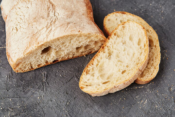 Bakery - gold rustic crusty loaves of bread and buns on grey chalkboard background.