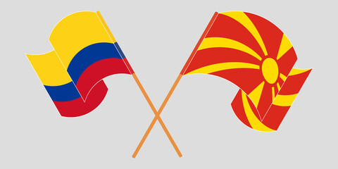 Crossed and waving flags of North Macedonia and Colombia