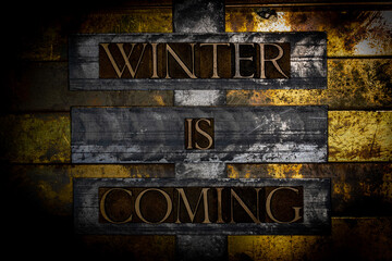 Winter Is Coming text message on textured grunge copper and vintage gold background