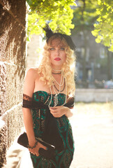Fototapeta premium Elegant young lady in fashionable dress retro style, natural beauty portrait outdoors in sunlight
