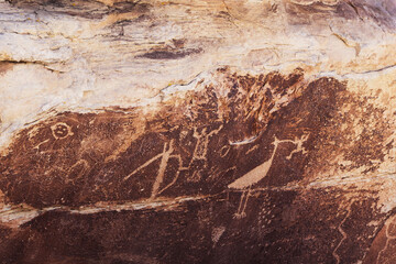 A petroglyph of a bird holding an object in its beak seen at Petrified National Forest, Arizona,...