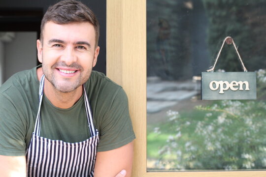Cute young entrepreneur with open sign