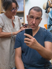 Wife is cutting hair of her husband at home in Coronavirus days.