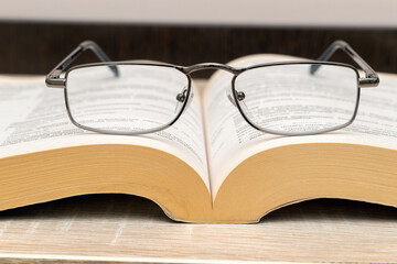 Glasses for reading on the book close up