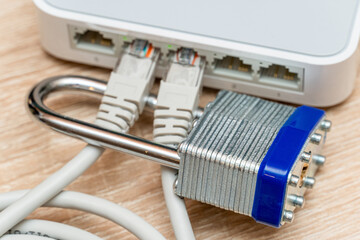 bundle of network Ethernet wires in router locked with metal padlock