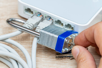 bundle of network Ethernet wires in router locked with metal padlock