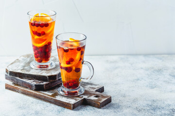 Orange and cranberry drinks with orange slices and spices. Hot drinks for winter and Christmas