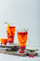 Orange and cranberry drinks with orange slices and spices. Hot drinks for winter and Christmas