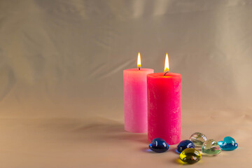 Obraz na płótnie Canvas A thin wax candle with a small lit flame with a background. Candles on an old table. Beautiful background. Religious concept.