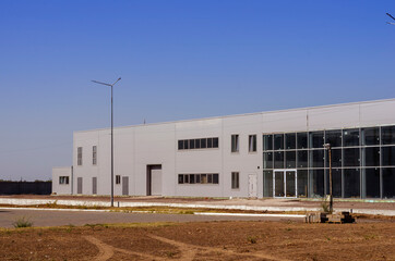 The facade of a corporate building under construction made of glass and concrete.