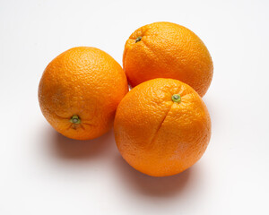 threesome oranges  on white background, supermarket presentation, high angle camera shoot