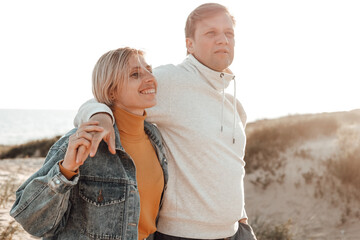 a man and a woman relax on the beach. Sunny day ,sunset . love story . family