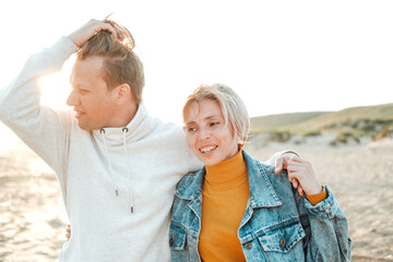 a man and a woman relax on the beach. Sunny day ,sunset . love story . family