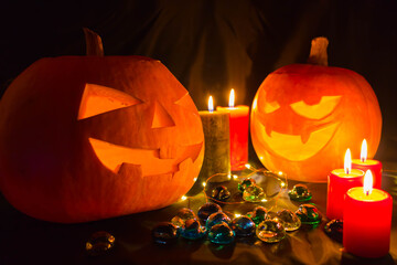 Halloween pumpkin. Candles, bat and glowing pumpkin. Harvest for Halloween. Dark atmosphere for holiday.