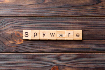 spyware word written on wood block. spyware text on cement table for your desing, concept