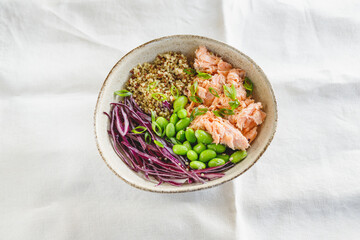Poke bowl with couscous, baked salmon, bean, and cabbage. Healthy eating concept.