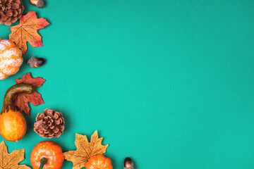 Green background with pumpkins, leaves and acorns
