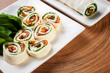 Buffalo mozzarella roll stuffed with dried tomatoes and arugula. Top view. Copy space