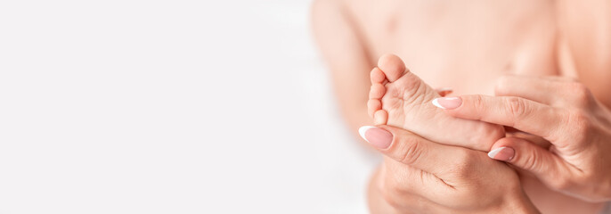 Close-up Foot massage for baby. Mother makes massage for happy, Health care concept. Long banner format. space for text