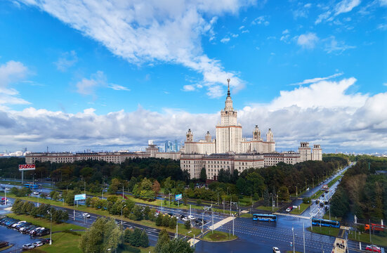 Moscow, Russia - 13 September 2020: Panoramic aerial view of dramatic cloudy sky over main building and campus park of Moscow university in autumn