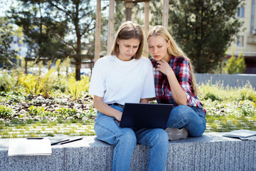 Fototapeta premium Two adult high school student girl spending time near campus