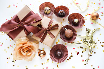 christmas gift concept. gift box, set of chocolates and Christmas tree decorations on a white background.