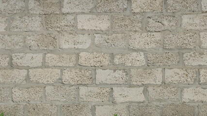 street gray background from textured rough blocks with thick concrete joints, pronounced texture of the stone surface of the urban space