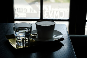 Beautiful serving of coffee, on golden diarrhea in a white paste with eyelash on flat white foam,...
