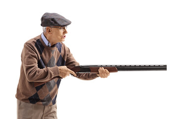 Angry old man aiming with a shotgun